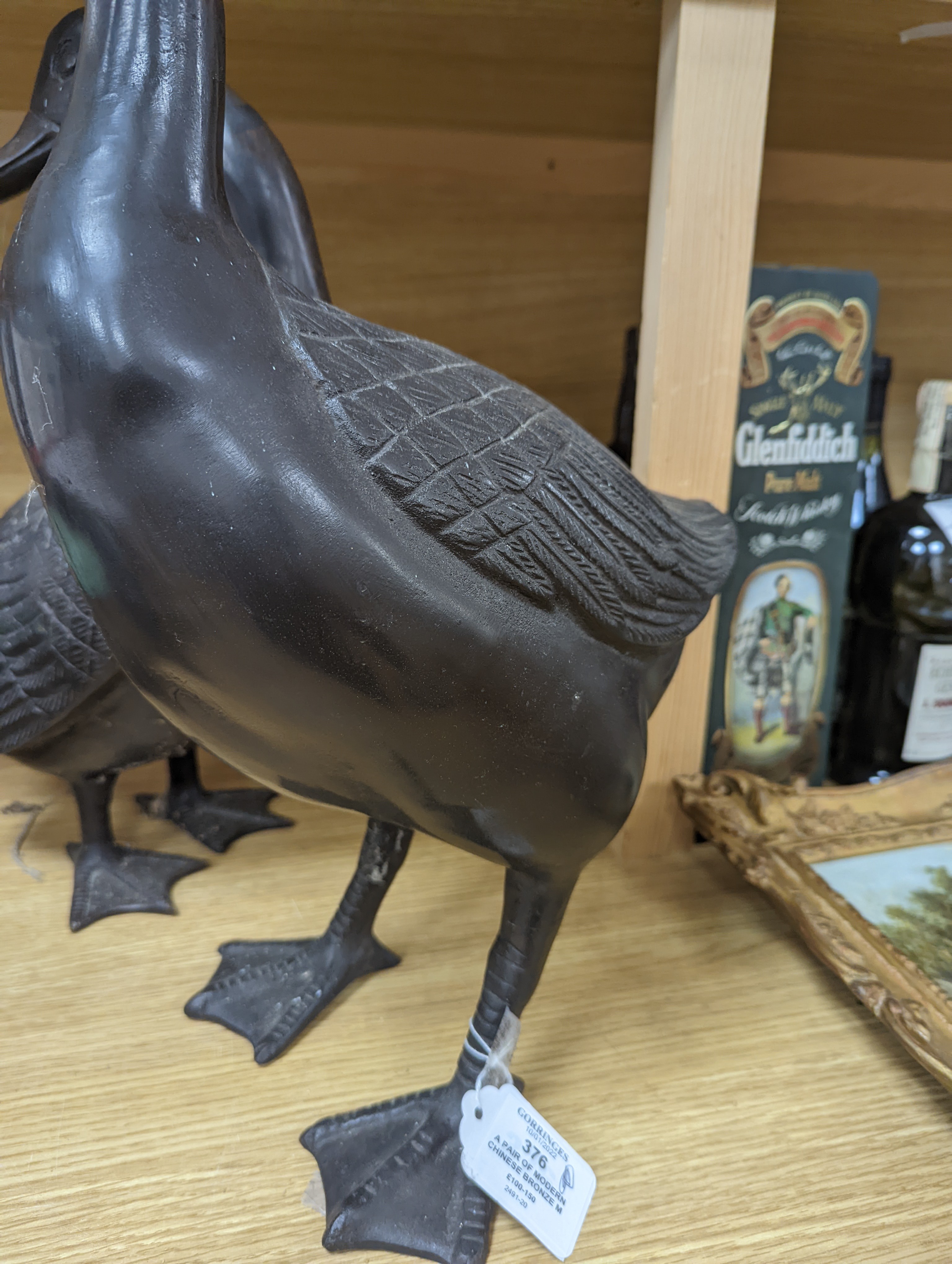 A pair of modern Chinese bronze models of geese, largest 48cm